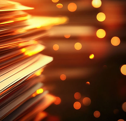 Stacked papers with warm bokeh background, symbolizing organization and productivity.