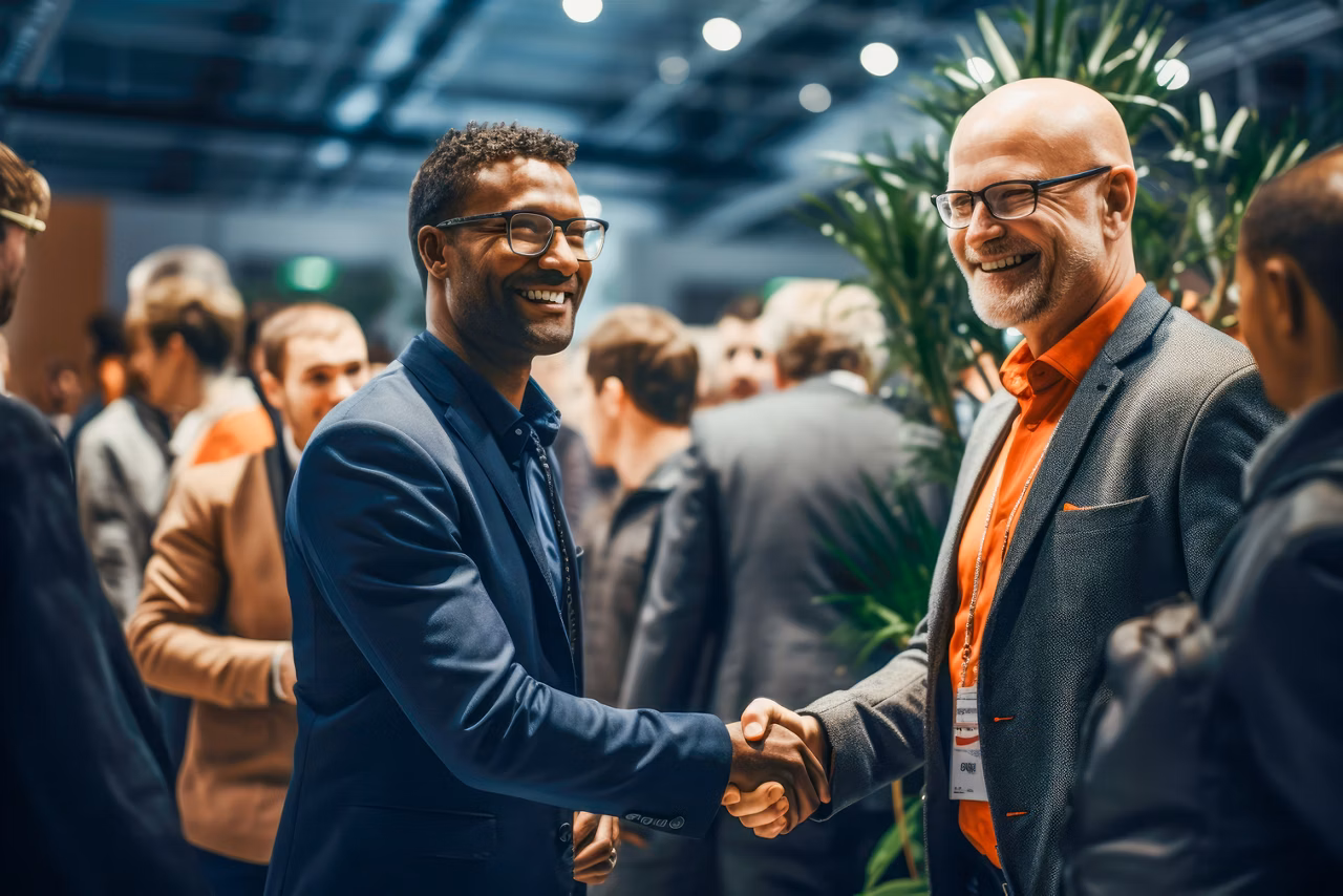 Strong handshake exchanged at a professional networking event or a conference.