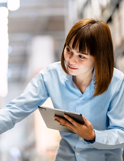 Women warehouse worker using digital tablets to check the stock inventory on shelves in large warehouses, a Smart warehouse management system, supply chain and logistic network technology concept