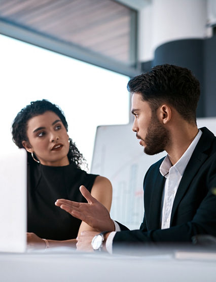 Serious, business meeting and people with laptop for performance review, communication and feedback. Corporate team, man and woman with computer in office for discussion and collaboration on project.