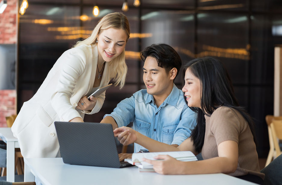 Team of business young man and woman discuss and working with laptop computer in the office workspace. Group of business man and women training or meeting together in the office