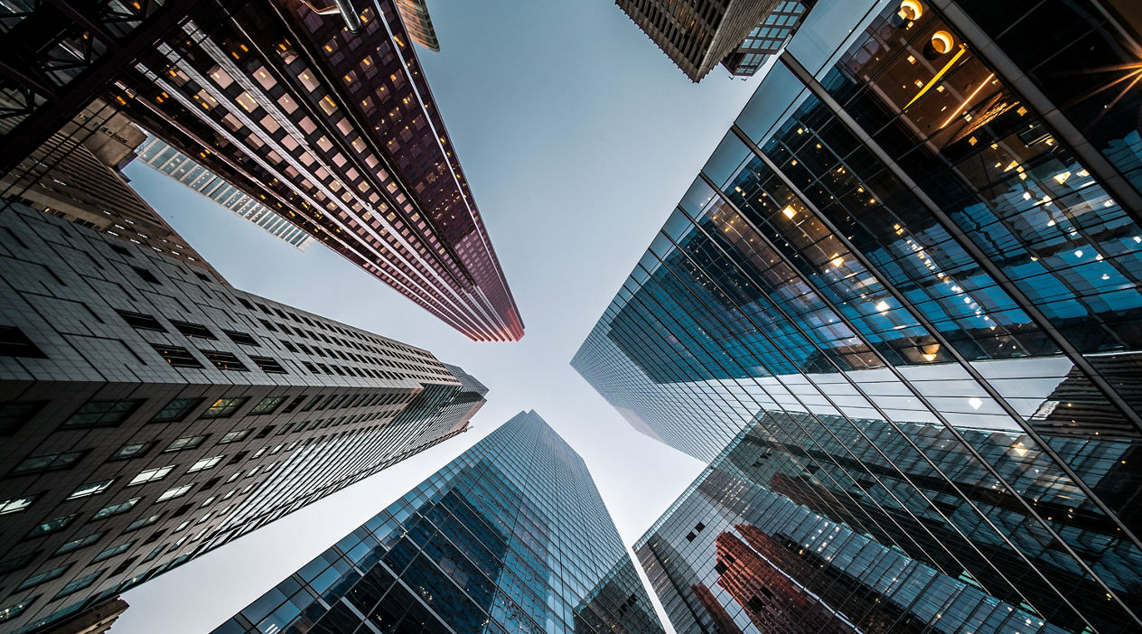 Business and finance concept, looking up at high rise office building architecture in the financial district of a modern metropolis.