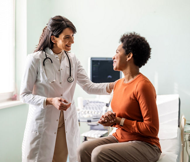 Female medical practitioner reassuring a patient