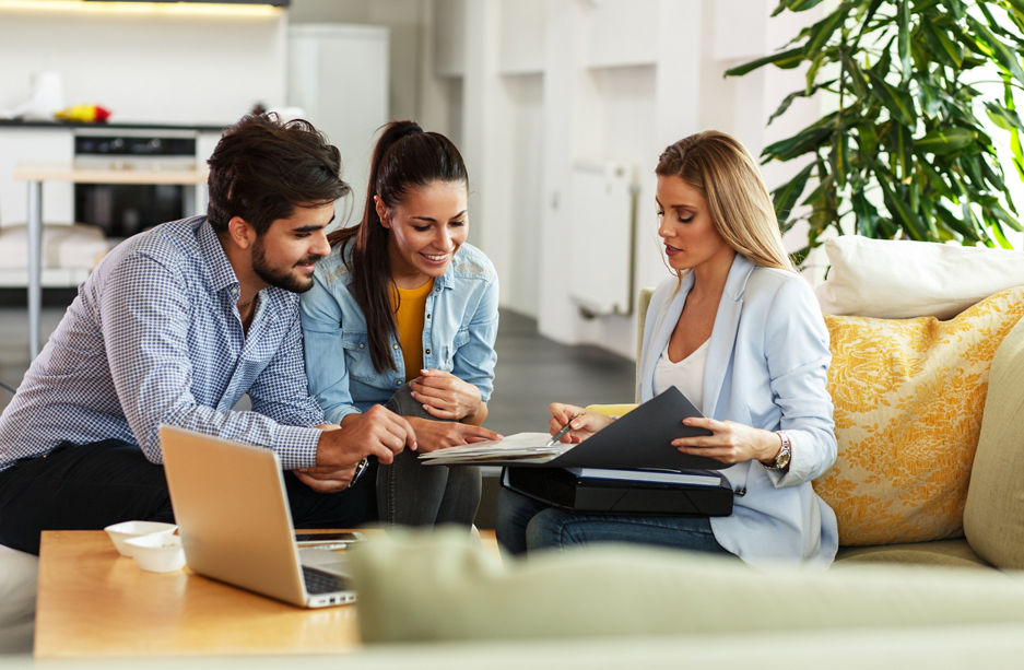 Female Real Estate agent offer home ownership and life insurance to young couple.
