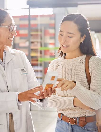 Asian woman, medicine shopping or pharmacist in pharmacy for retail healthcare product information. Women or friendly doctor helping a customer with store medication advice, pills or medical drugs.
