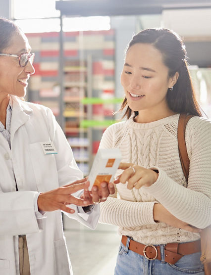 Asian woman, medicine shopping or pharmacist in pharmacy for retail healthcare product information. Women or friendly doctor helping a customer with store medication advice, pills or medical drugs.