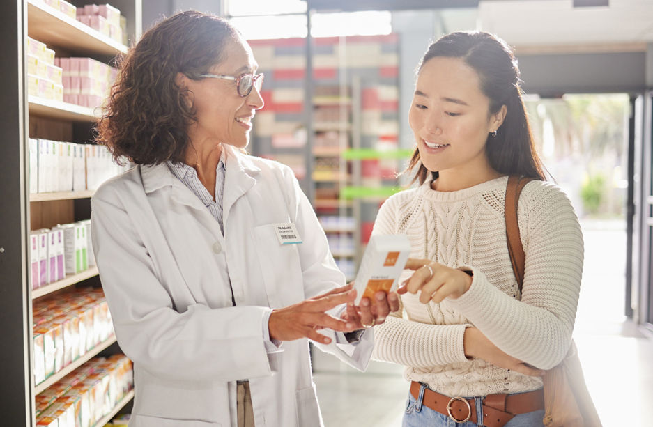 Asian woman, medicine shopping or pharmacist in pharmacy for retail healthcare product information. Women or friendly doctor helping a customer with store medication advice, pills or medical drugs.
