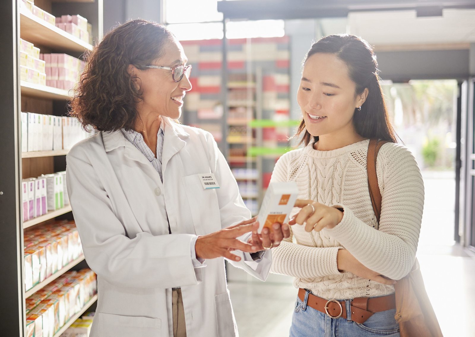 Asian woman, medicine shopping or pharmacist in pharmacy for retail healthcare product information. Women or friendly doctor helping a customer with store medication advice, pills or medical drugs.
