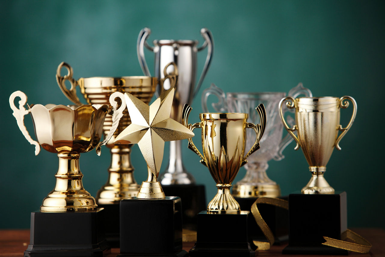 Group of the trophies on the green background