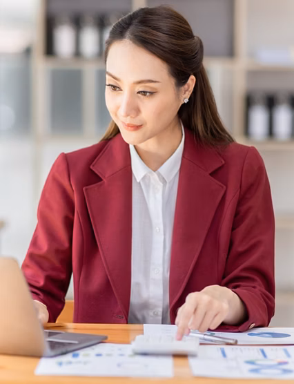 Asian woman working laptop in workplace, Business woman wearing red jacket suit busy working on laptop computer checking finances, investment, economy, saving money or insurance concept