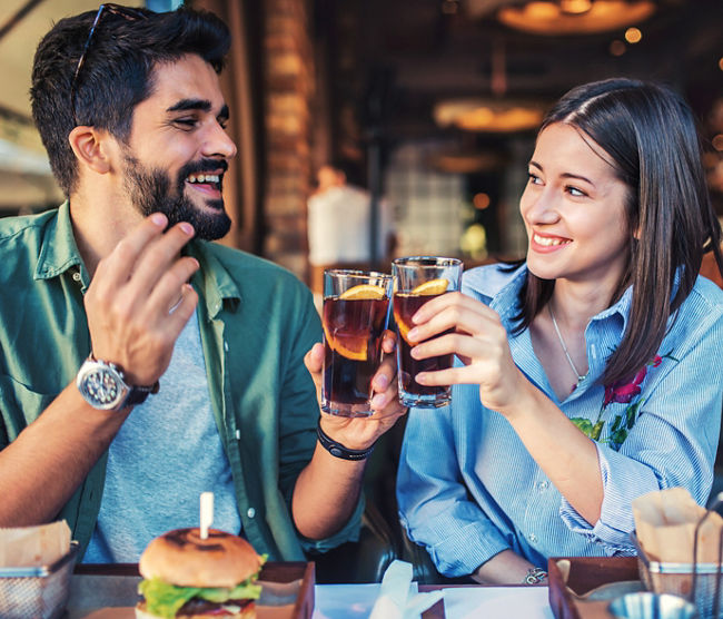 Happy loving couple enjoying breakfast in a cafe. Love, dating, food, lifestyle concept