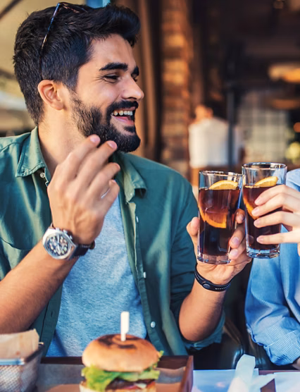 Happy loving couple enjoying breakfast in a cafe. Love, dating, food, lifestyle concept