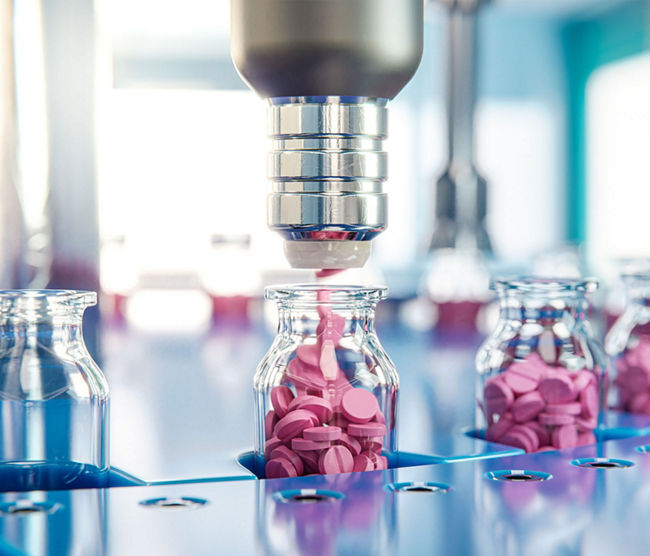 machine filling containers with pink liquid