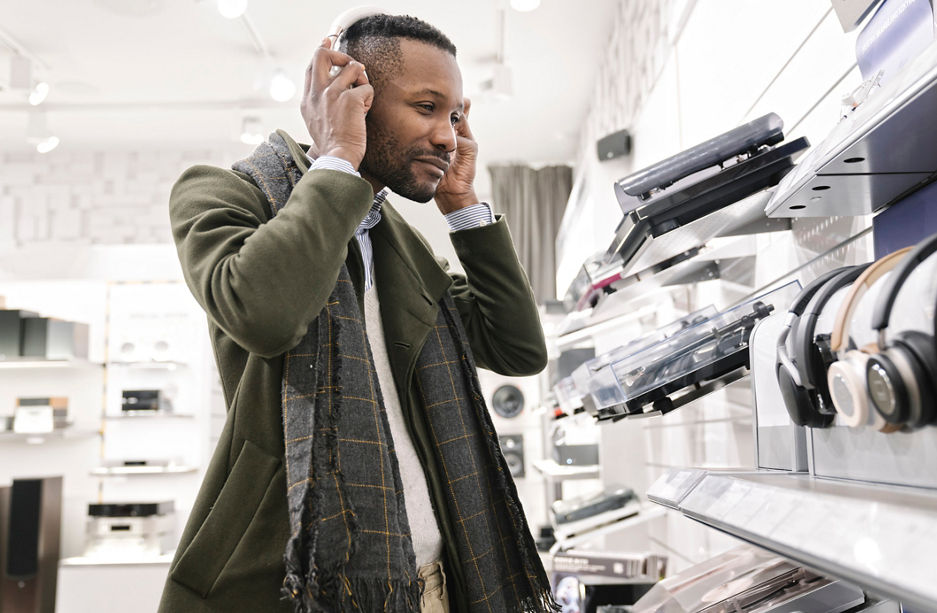 Man trying headphones in a store