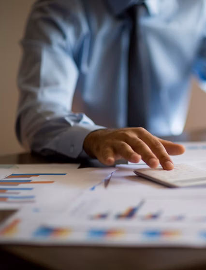 Business accounting concept, Business man using calculator with computer laptop, budget and loan paper in office.