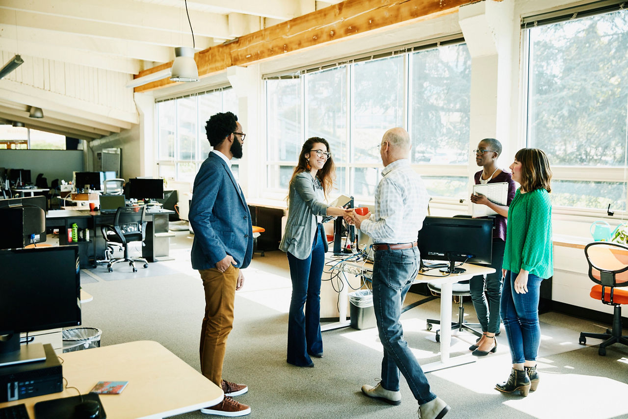 Businesswoman shaking handing with client before meeting in start up office