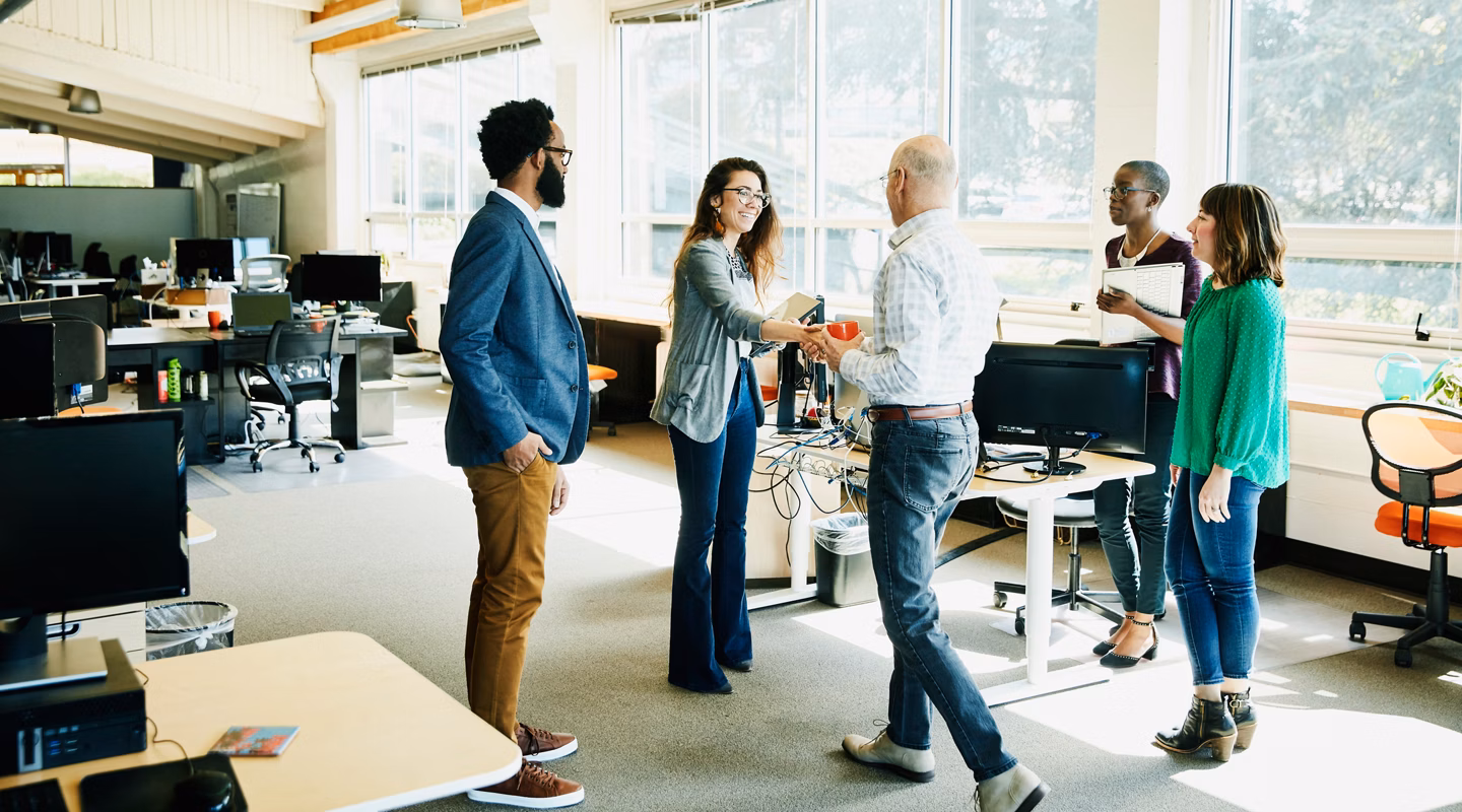 Businesswoman shaking handing with client before meeting in start up office