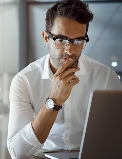 Cropped shot of a handsome young businessman looking thoughtful while working on his laptop in the office.