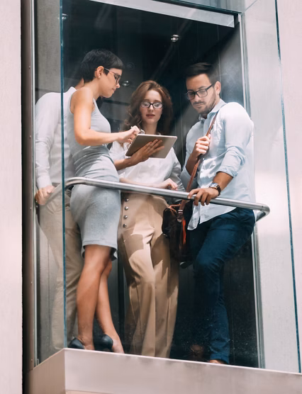 Picture of young attractive businesspeople talking in elevator