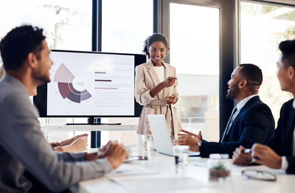 Shot of a young businesswoman delivering a presentation to her colleagues in the boardroom of a modern office