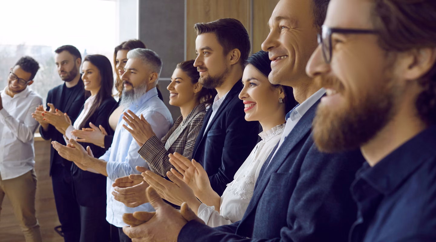 Narrow crop shot of businesspeople clap hands congratulate colleague with promotion or success in office. Smiling employees applaud show appreciation and acknowledgement. Closeup, banner.