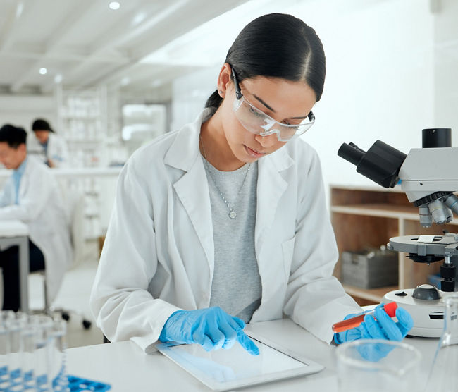 Scientist, woman and test tube with tablet in lab for dna analysis, medical research or pharmaceutical trial. Pharma company, professional or blood vial for vaccine development or experiment with ppe.