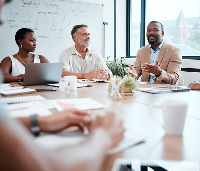 Happy business people, meeting and strategy in planning, team discussion or sharing idea at office. Group of employees in teamwork, collaboration or discussing project plan in conference at workplace.