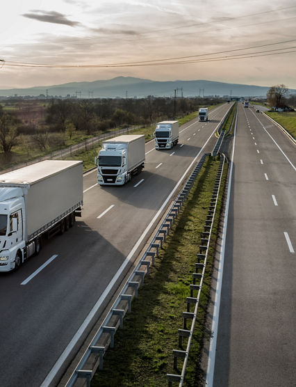 Caravan or convoy of trucks in line on a country highway