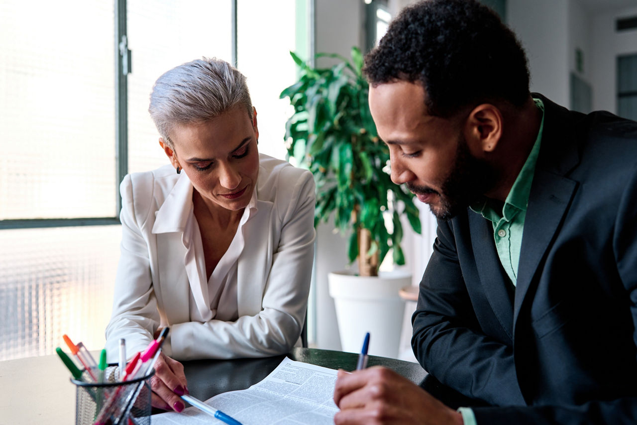 Lawyer reading a document during a meeting with a customer