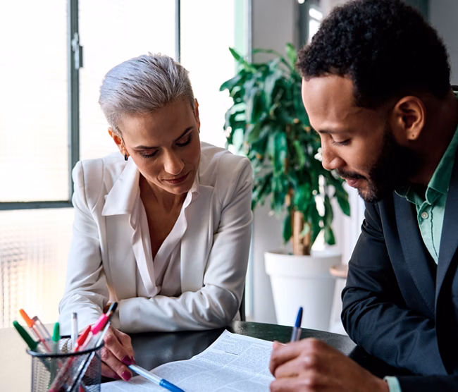 Lawyer reading a document during a meeting with a customer