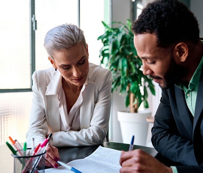 Lawyer reading a document during a meeting with a customer