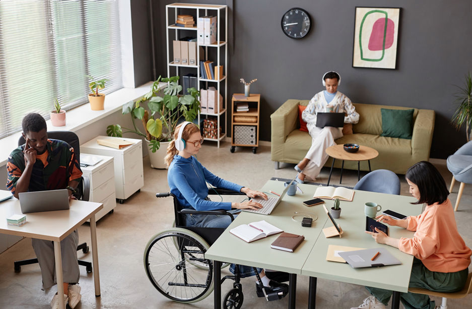 High angle view at modern office with diverse young people working at separate tasks, copy space