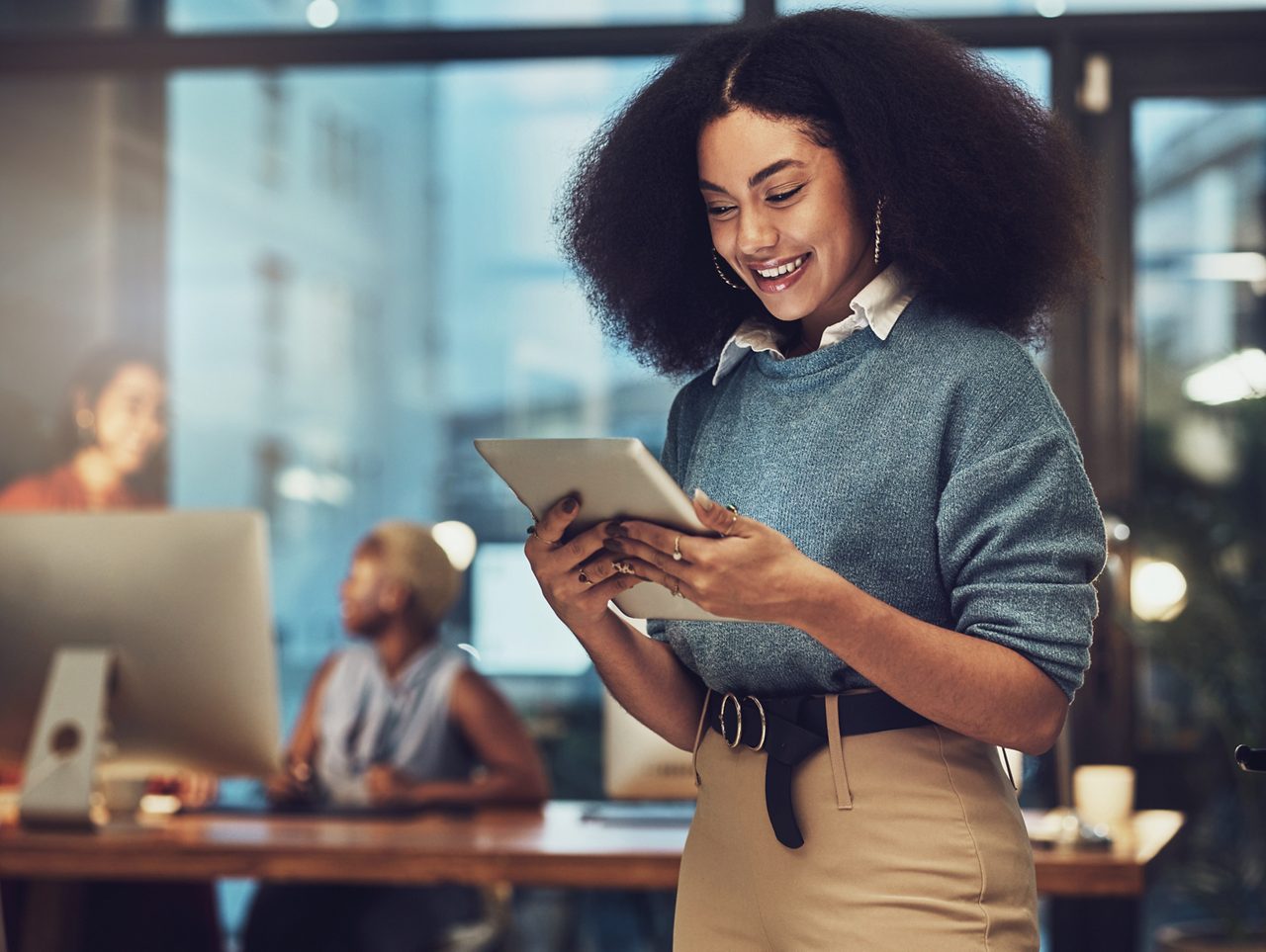 Business, tablet and night with woman in office for technology, happy and communication. Social media, connection and internet with female and search online for networking, email and website.