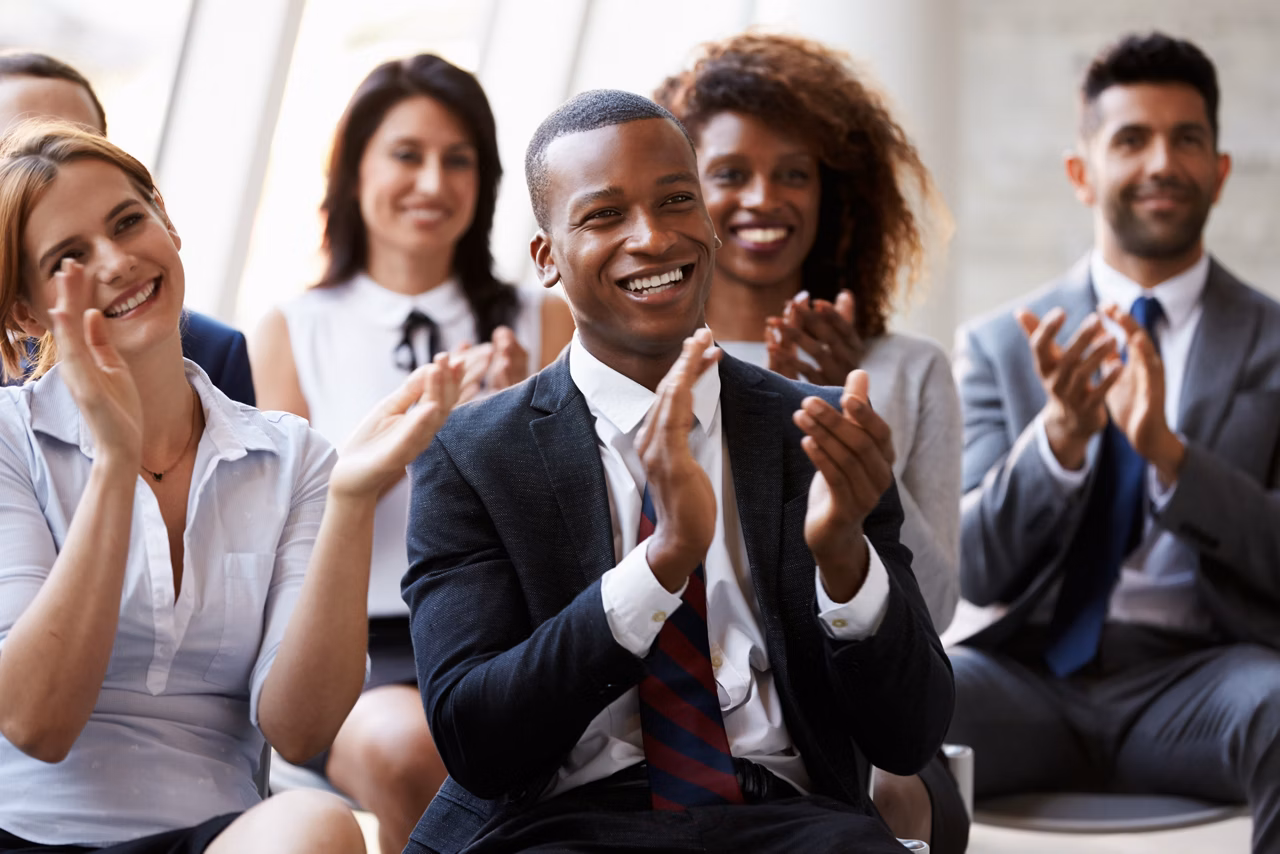 Audience Applauding Speaker At Business Conference