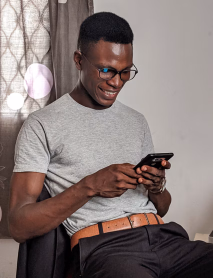 Man looking at his phone and smiling