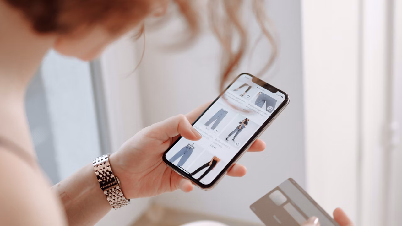 Woman shopping on her phone with a credit card
