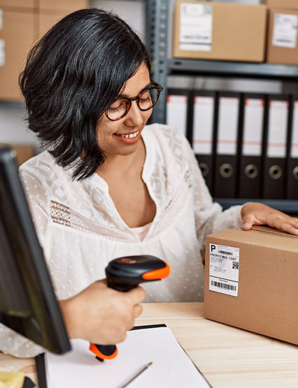 Young latin woman ecommerce business worker scanning package at office