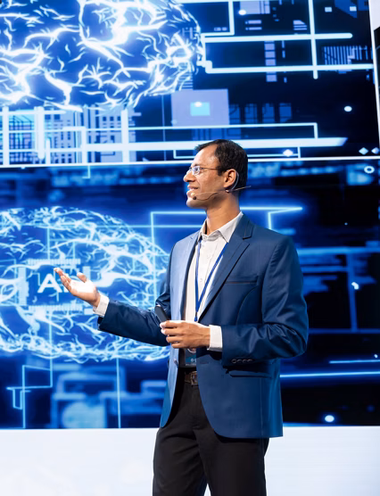 Cheerful presenter speaking at tech conference, exploring latest AI technology trends and case studies. Upbeat IT professional presenting how artificial intelligence is shaping future during event