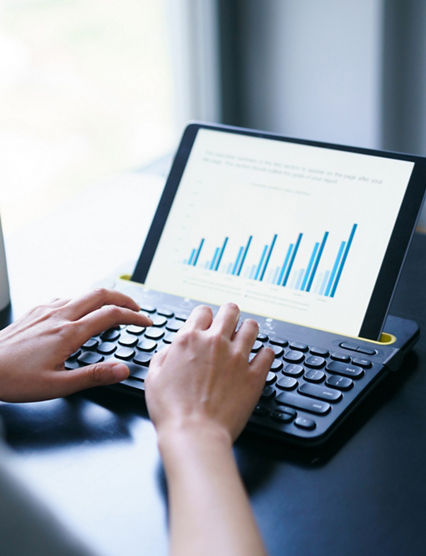 asian business woman working with business report on digital tablet