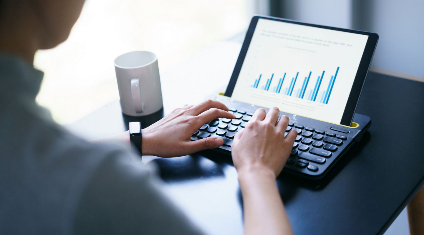 asian business woman working with business report on digital tablet