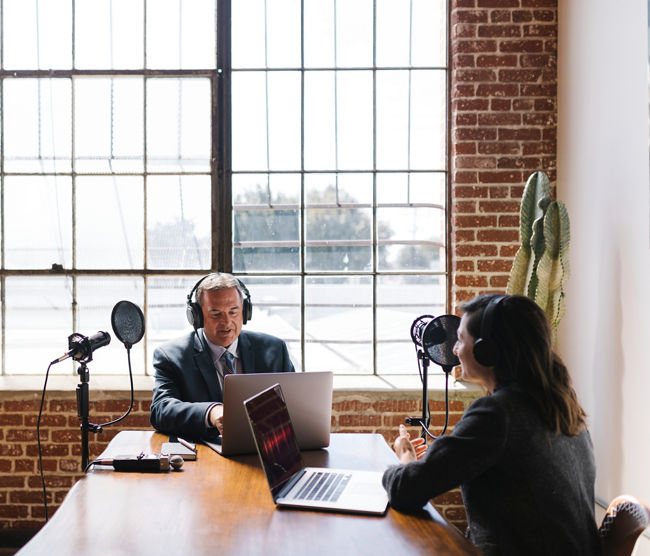 Female broadcaster interviewing her guest in a studio