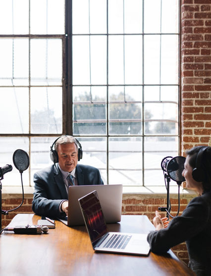 Female broadcaster interviewing her guest in a studio