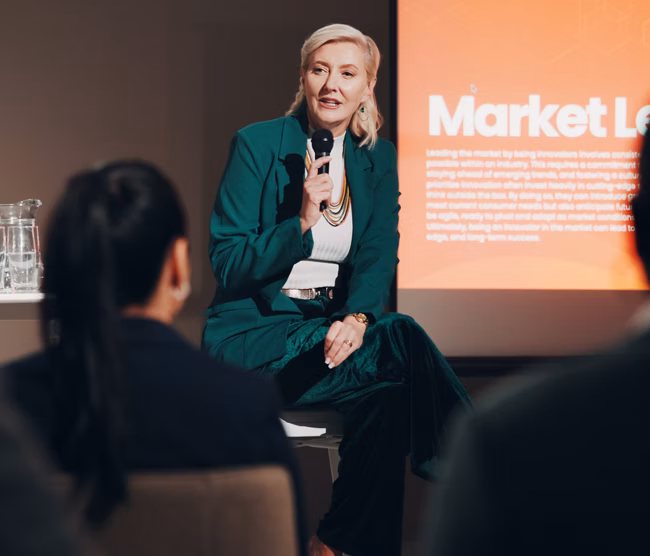 Mature woman, stage and seminar with microphone for leadership skills, information or knowledge. Female person, public speaker and presentation at global summit, conference or motivation in uplifting.