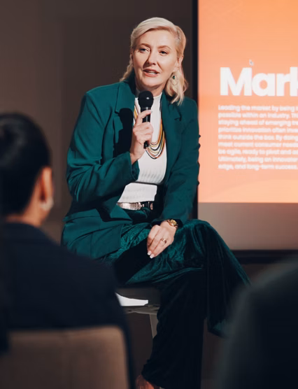 Mature woman, stage and seminar with microphone for leadership skills, information or knowledge. Female person, public speaker and presentation at global summit, conference or motivation in uplifting.