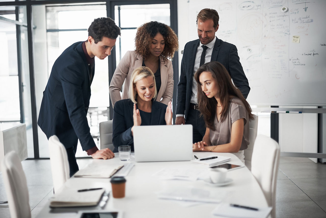 Business people, meeting with paperwork and laptop training with ideas in job collaboration on project proposal. Teamwork, strategy and coaching workshop, men and women in target management at office.
