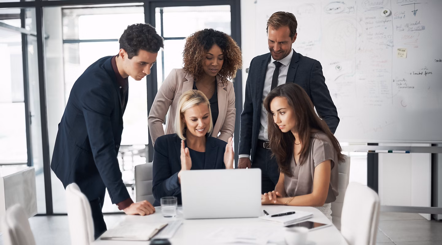 Business people, meeting with paperwork and laptop training with ideas in job collaboration on project proposal. Teamwork, strategy and coaching workshop, men and women in target management at office.