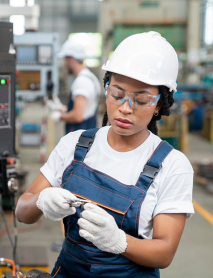 Female Engineer Programming A CNC Machine At Factory