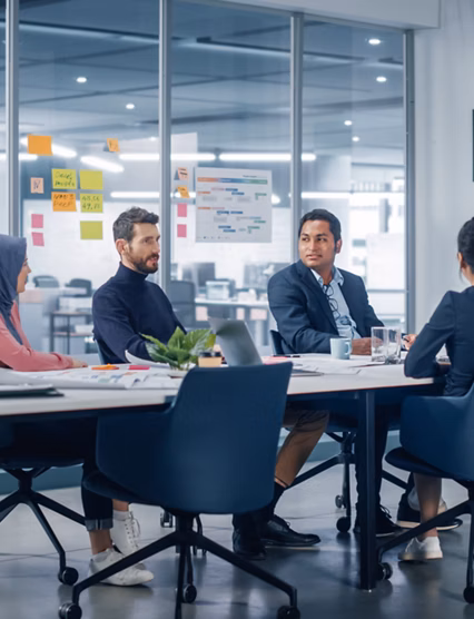 Businesspeople do Video Conference Call with Big Wall TV in Office Meeting Room. Diverse Team of Creative Entrepreneurs at Big Table have Discussion. Specialists work in Digital e-Commerce Startup