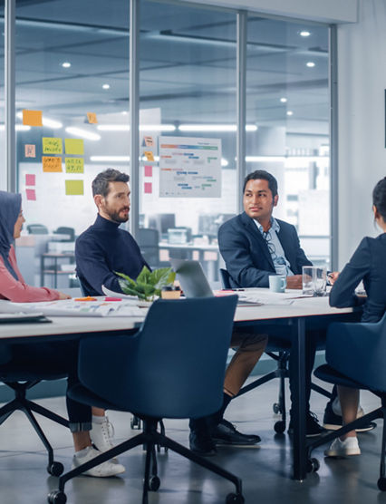 Businesspeople do Video Conference Call with Big Wall TV in Office Meeting Room. Diverse Team of Creative Entrepreneurs at Big Table have Discussion. Specialists work in Digital e-Commerce Startup