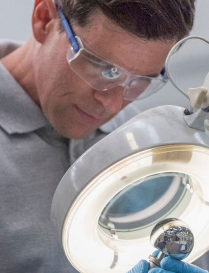 man looking at a part through a telescope